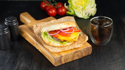 burger in pita breads with grilled meat, vegetables and sauce on dark background. banner, menu, recipe.