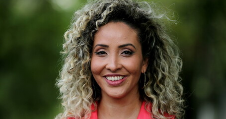 Happy hispanic woman smiling and laughing at camera, portrait latin person face close-up