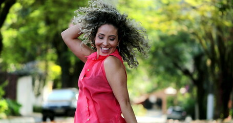 Happy hispanic woman dancing outside celebrating life - Powered by Adobe