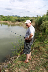 Senior man fishing in the pond