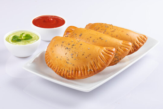 Chicken patis on white with sauce