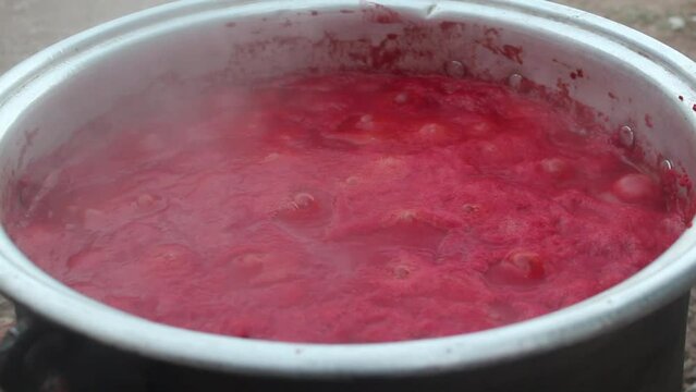 
Tomatoes boiled in a cauldron on a hot fire turn into tomato paste.