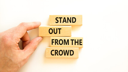 Stand out from the crowd symbol. Concept words Stand out from the crowd on wooden blocks on...
