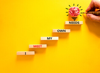 I meet my own needs symbol. Concept words I meet my own needs on wooden blocks. Businessman hand. Beautiful yellow table yellow background. Business and i meet my own needs concept. Copy space. - obrazy, fototapety, plakaty
