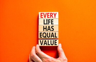 Every life has equal value symbol. Concept words Every life has equal value on wooden blocks. Businessman hand. Beautiful orange background. Business and every life has equal value concept. Copy space