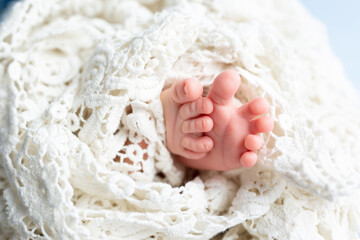 small feet of a newborn baby on a white background
