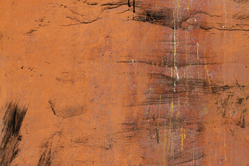 Fototapeta na wymiar The texture is a rusty metallic orange painted surface with paint cracks and rust spots. background