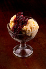 vanilla ice cream cup dessert with brownie and berry sauce top view