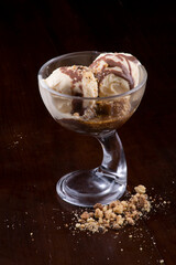 vanilla ice cream cup dessert with brownie and hot chocolate sauce and farofa