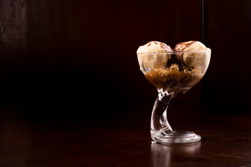 vanilla ice cream cup dessert with brownie and hot fudge syrup landscape