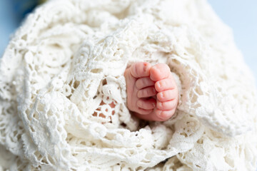 small feet of a newborn baby on a white background