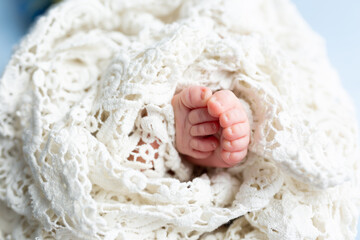 small feet of a newborn baby on a white background