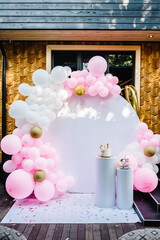 Arch decorated with pink, white and gold balloons. Trendy Cake for a girl. Copy space. Birthday...