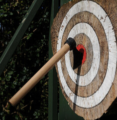 Throwing axe in bullseye of target