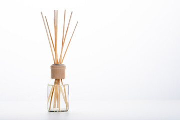 Aroma sticks for home comfort. Wooden scented sticks in a glass bottle.