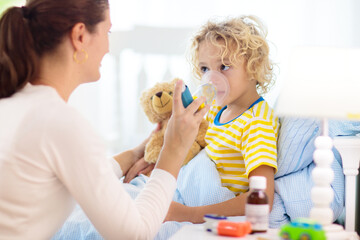 Obraz na płótnie Canvas Sick little boy with asthma medicine. Ill child.