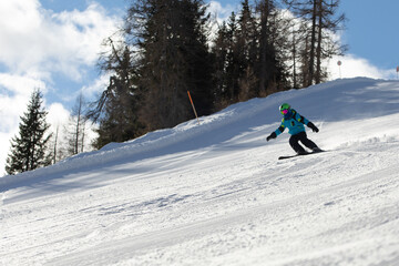 Fototapeta na wymiar A child while skiing in a ski resort.