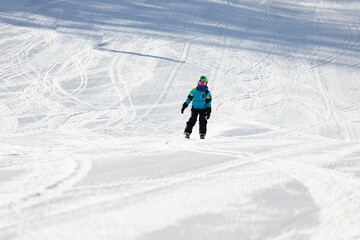 A child while skiing in a ski resort.