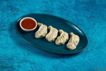 Steamed chicken mom wrap with ketchup served in a dish isolated on background top view