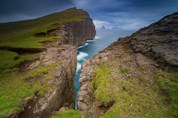 Trælanípan is one of the most renowned nature attractions in the Faroe Islands. From Trælanípan, in English the Slave Cliff, you can see the lake overlooking the salty North Atlantic ocean.