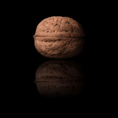Inshell walnuts on a black background.