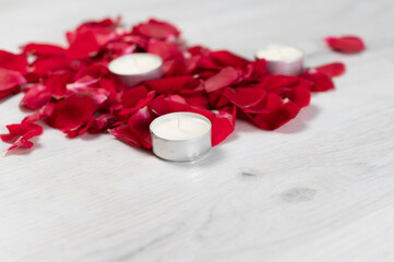 Rose petals and scented candles on the floor.