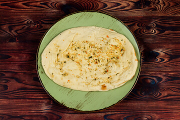 Roghni naan, khamiri roti, kulcha, bread, or chappati served in a dish isolated on background top view