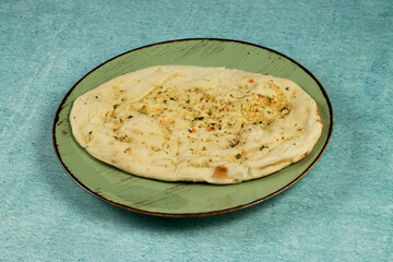 Roghni naan, khamiri roti, kulcha, bread, or chappati served in a dish isolated on background top view