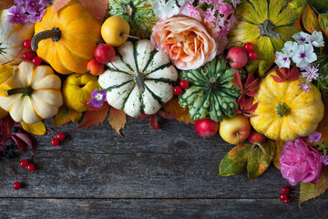 Wooden background with pumpkins, fruits, flowers, plants, leaves, apples, roses, phlox, decorative...