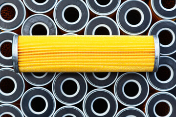 New yellow machine filters, stacked to each other and one filter on top of them.