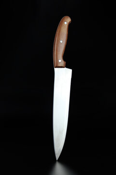 Knife weapon cook stainless. Chefs knife on black background.