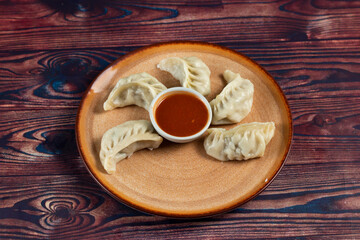 Steamed chicken mom wrap with ketchup served in a dish isolated on background top view