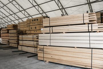 Stacks of lumber on a rack for sale to consumers at a retail hardwood lumber business