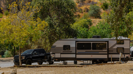 Camping in a trailer in autumn in a camper amongst the trees 