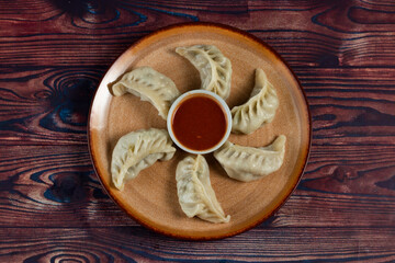 Steamed chicken mom wrap with ketchup served in a dish isolated on background top view