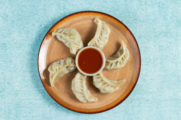 Steamed chicken mom wrap with ketchup served in a dish isolated on background top view