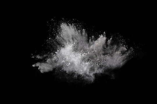 White powder explosion on black background. Colored cloud. Colorful dust explode. Paint Holi.
