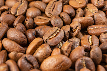 Coffee beans detailed on the background, aromatic coffee beans, place for inscription.