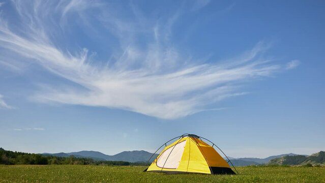 Morning timelapse 4K. Tourist tent in camp among alpine meadows in the mountains 