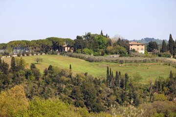 Amazing landscape of the Tuscan countryside with the typical rolling hills and cypresses to mark the boundaries