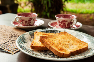 Evening English tea with toasted bread outside of the house, in the garden or lawn