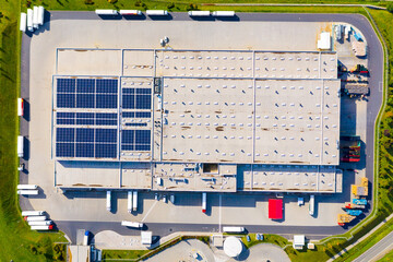 Industry with low carbon footprint. Industrial warehouses with solar panels on the roof. Technology park and factories  from above. - 536168919