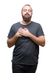 Young caucasian hipster man over isolated background smiling with hands on chest with closed eyes and grateful gesture on face. Health concept.