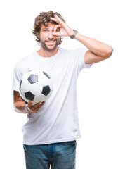 Handsome hispanic man model holding soccer football ball over isolated background with happy face...