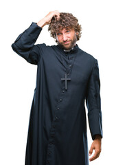 Handsome hispanic catholic priest man over isolated background confuse and wonder about question. Uncertain with doubt, thinking with hand on head. Pensive concept.