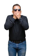 Middle age arab man wearing sunglasses over isolated background shocked covering mouth with hands for mistake. Secret concept.
