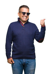 Middle age arab man wearing sunglasses over isolated background smiling with happy face looking and...