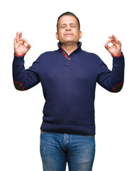 Middle age arab man over isolated background relax and smiling with eyes closed doing meditation gesture with fingers. Yoga concept.