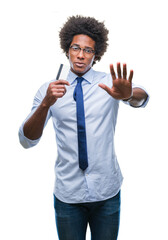 Afro american man holding credit card over isolated background with open hand doing stop sign with serious and confident expression, defense gesture