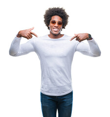 Afro american man wearing sunglasses over isolated background looking confident with smile on face, pointing oneself with fingers proud and happy.